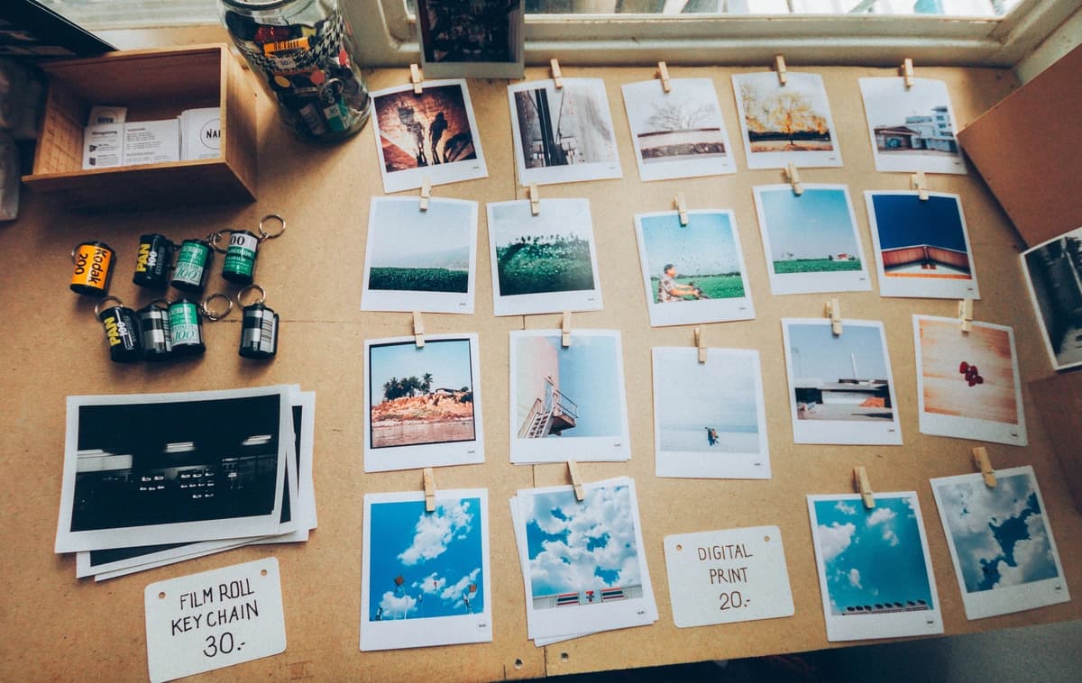 Cork board filled with travel polaroid photos