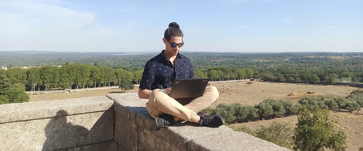 Man working on a laptop while on vacation