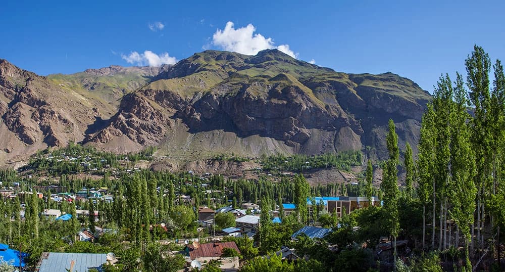 Mountains and tall, green trees in Tajikistan