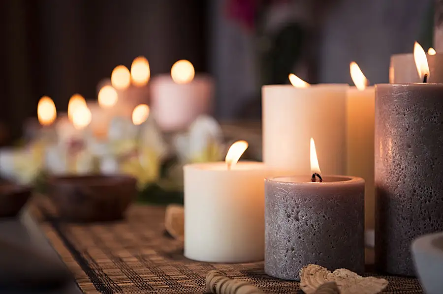 Dozens of candles on a shelf, very zen feeling