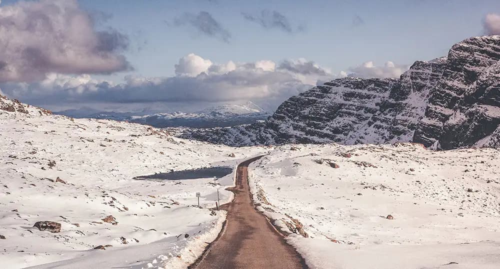 Road running through snowy mountains